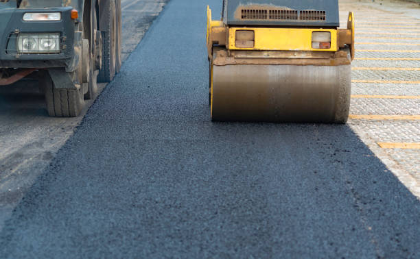 istock Worker leads the vibrating road roller to compact the asphalt laid out for the construction of a road, Selective focus 1301385851