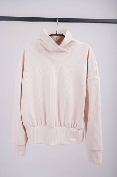 istock Knitted beige jacket hanging on an isolated background 1301386072
