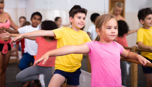 istock Boys and girls training along ballet bar 1301386142