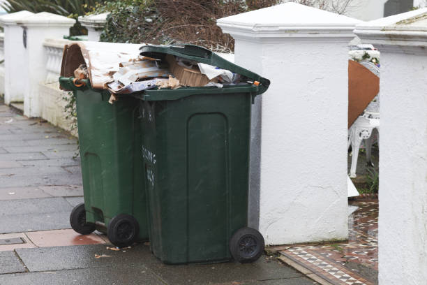 Household waste bin Wheelie bins on a pavement waiting for rubbish collection, UK. overflowing trash dumpster stock pictures, royalty-free photos & images