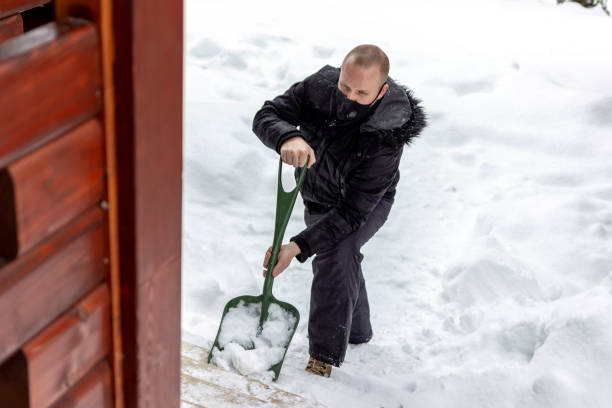 istock Man cleaning snow with shovel in winter day. 1301387335
