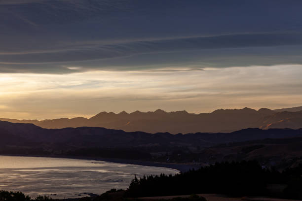 istock Colorful ocean beach sunrise with deep blue sky and sun rays. 1301387575