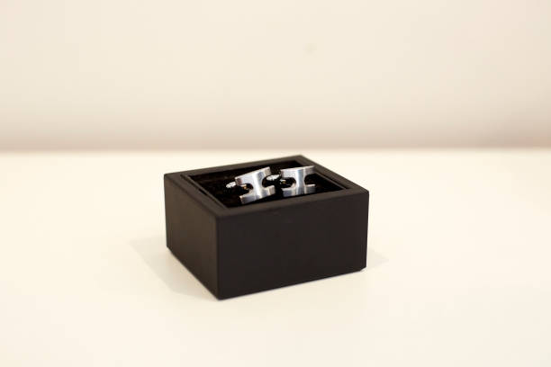 istock Silver cufflinks on a black case. Still life. Masculine accessory 1301387824