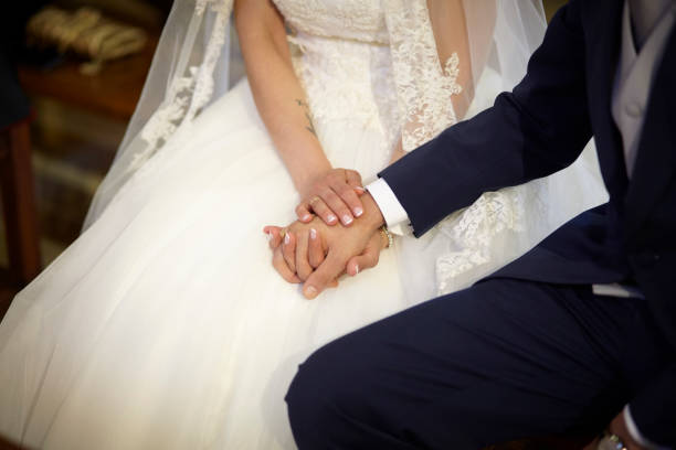 istock Bride and groom holding hands. Unrecognizable people. Couple 1301389276
