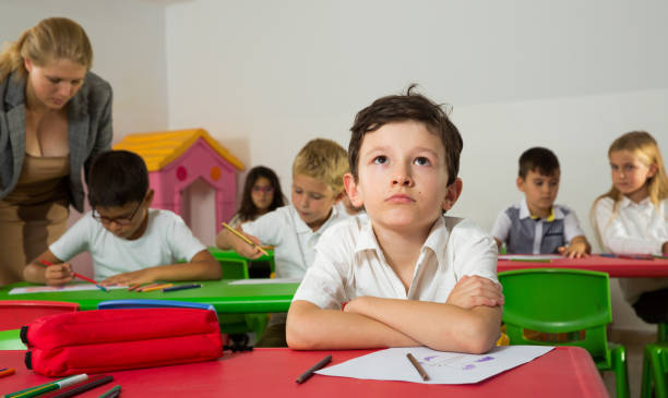 istock Portrait of bored schoolboy 1301389712
