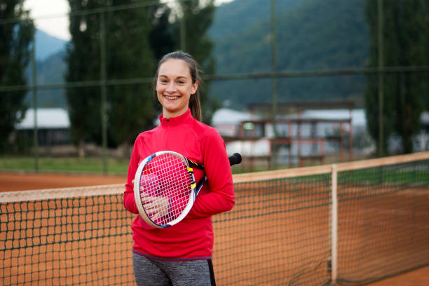Beautiful female tennis player with tennis racket