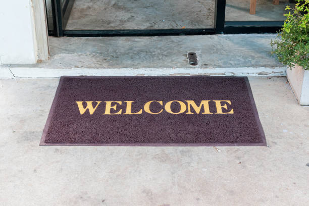 Welcome mat in shop front of door. stock photo