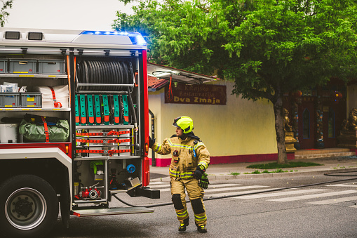 Celje, Slovenia - May 28, 2020: Fire department blocking the streets of Celje, while trying to put out a real fire in a Chinese restaurant on a rainy day