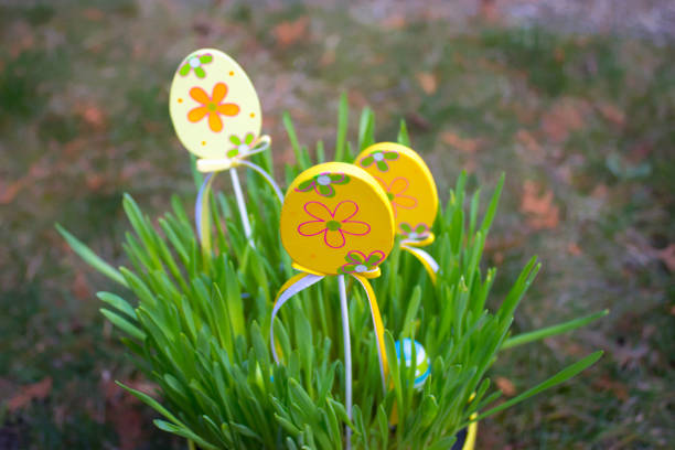 There is an Easter decoration eggs in grass in the flowerpot.