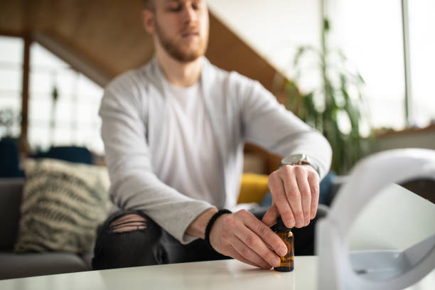 istock Young man using essential oil for his beard treatment at home 1301397372