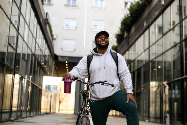 istock Young man riding a bicycle in the city 1301398616