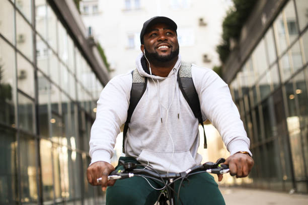 istock Young man riding a bicycle in the city 1301398625
