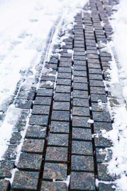 istock Stone path in the park in the snow close-up. 1301399871