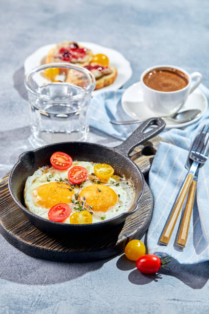 istock Fried eggs in cast-iron skillets. Sunny morning breakfast concept 1301400313