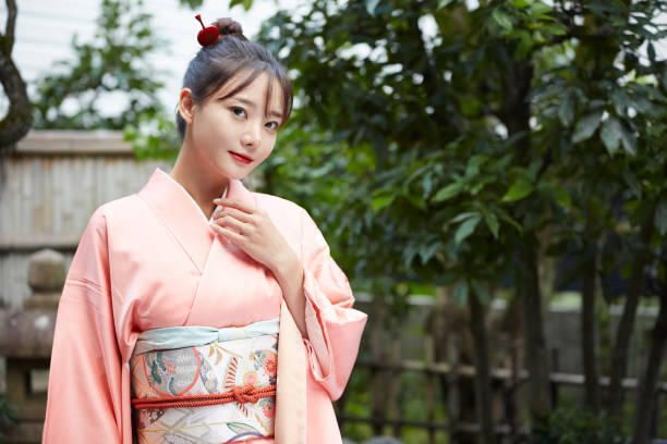 A young woman in a kimono is walking around