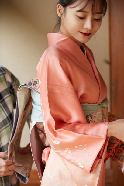 istock A young woman getting dressed in a kimono 1301401112