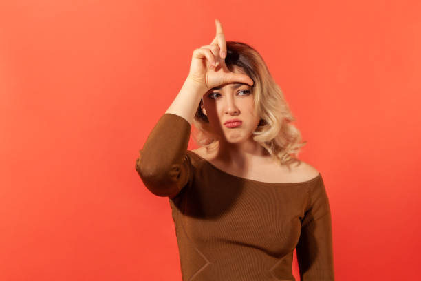 istock Sad woman showing loser gesture 1301401273