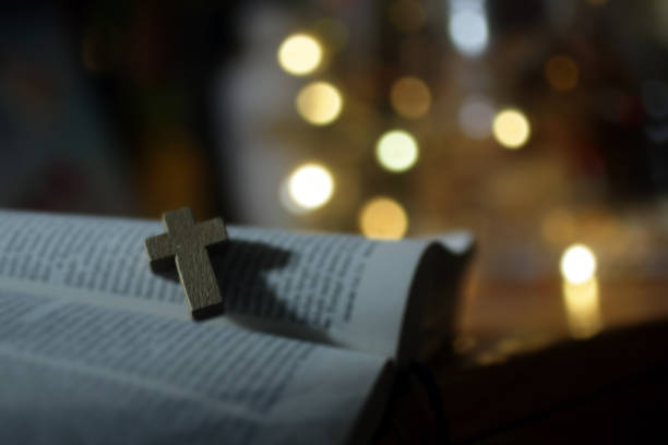istock Chrsitian cross on bible book 1301402704