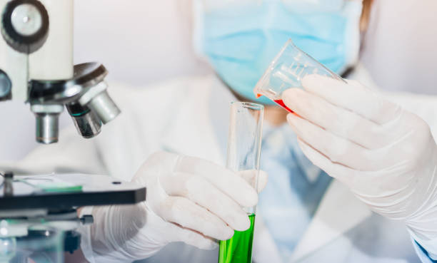 istock scientist with equipment and science experiments laboratory glassware containing chemical liquid. 1301402740