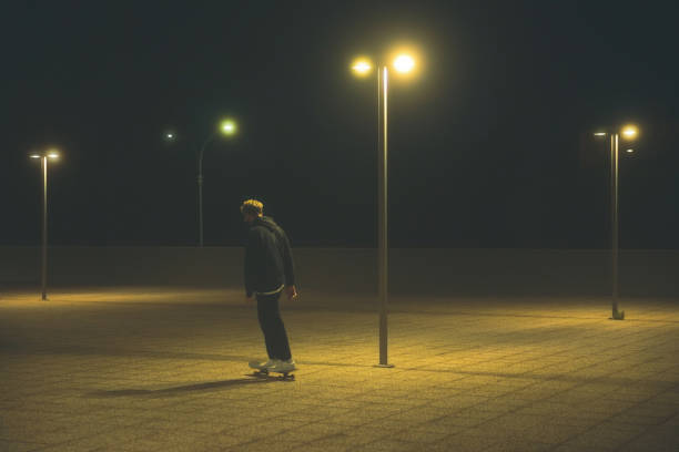 istock Young Men With Skateboard at Night 1301402994