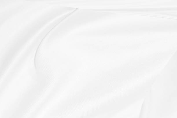 istock Clean shiny woven decorative fashion textile soft fabric white abstract smooth curve shape background 1301407141