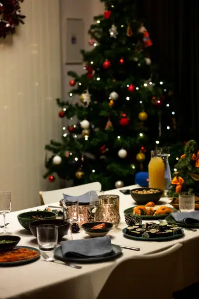 December 24, 2020 - Warsaw, Poland: Real life Christmas dinner table - festive environment, Christmas tree.