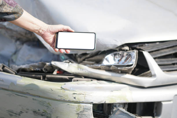 istock hand take photo of crashed damaged broken car. automobile crash accident 1301407916
