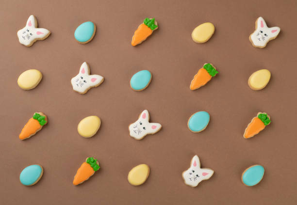 istock Bunny, egg and carrot easter cookies over brown background 1301409368