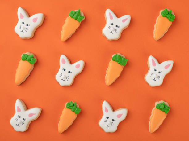 istock Bunny and carrot easter cookies over orange background 1301409385
