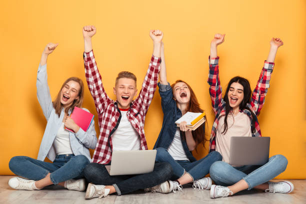 istock Group of young cheerful school friends doing homework 1301412031