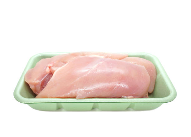 istock Raw chicken fillets in polystyrene container isolated on white background. Uncooked chicken breast without skin in the package. 1301413330