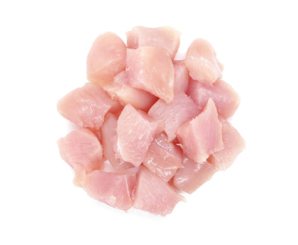 Pieces of chicken fillets isolated on white background. Small pieces of raw meat. Top view. Pieces of chicken fillets isolated on white background. Small pieces of raw meat. Top view. chicken breast photos stock pictures, royalty-free photos & images