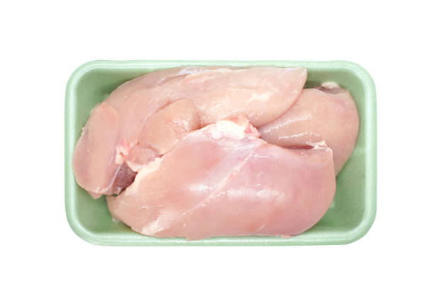 istock Chicken fillets in polystyrene container isolated on white background. Raw uncooked chicken breast without skin in the package. Top view. 1301413368