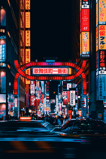 Busy streets of Shinjuku, Tokyo with neon lights and traffic