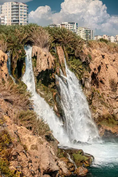 Photo of Picturesque and powerful Duden waterfall, a water stream breaks from a high cliff - this is a very popular place for tourists and a business card of Antalya and Turkey