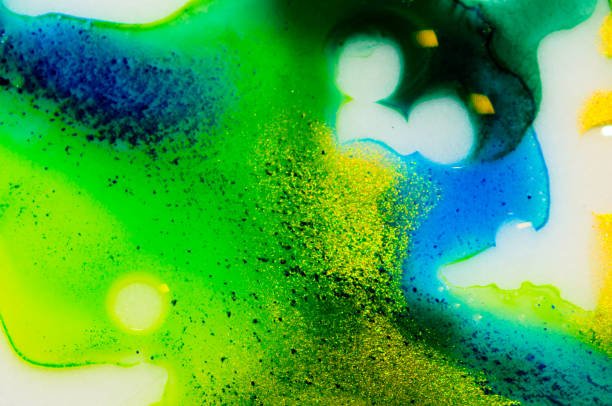 istock Liquid bright aquarel colours with oil generate fluid structures and bubbles in green, blue, yellow, white and gold 1301415806