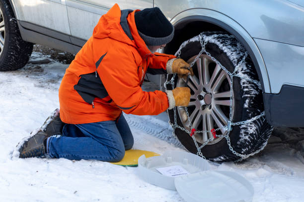 putting on snow chains - medium shot imagens e fotografias de stock