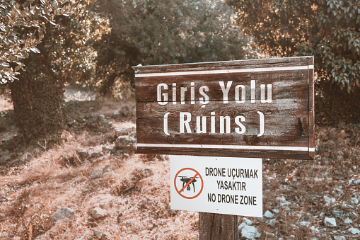 Sign forbidding flying on drones and copters at the entrance to the ancient Lycian city in Turkey