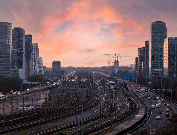 High angle view of Freeway and tracks through the zuid-as Amsterdam business district at sunset.