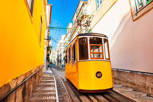 Yellow funicular on the railway in Lisbon, Portugal.