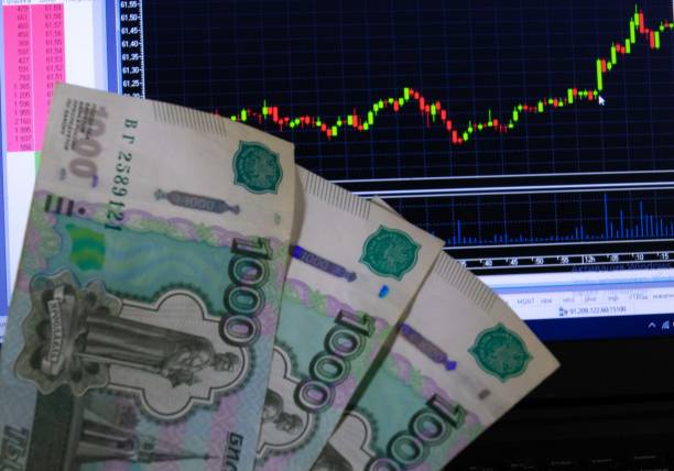 istock Candlelight red green graph and paper rubles 1301422909