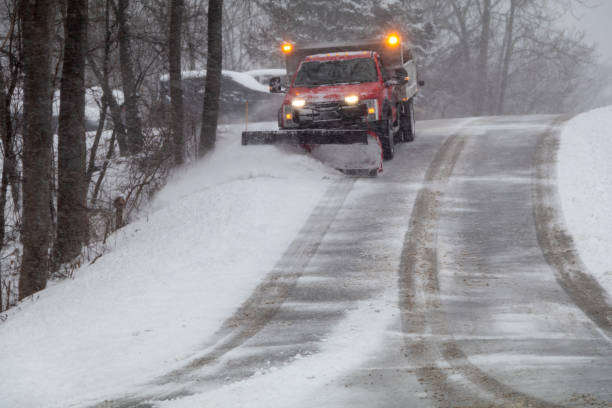 istock Snowplow in action clearing residential roads during snow storm 1301423232