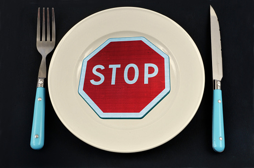 Diet concept with a stop sign on a plate