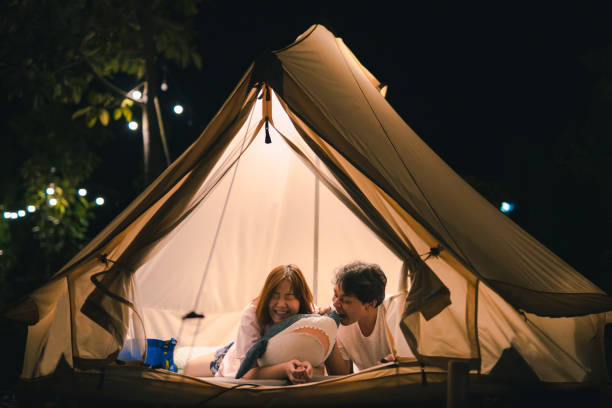 istock asian couple relax in camping tent on summer vacation 1301424730