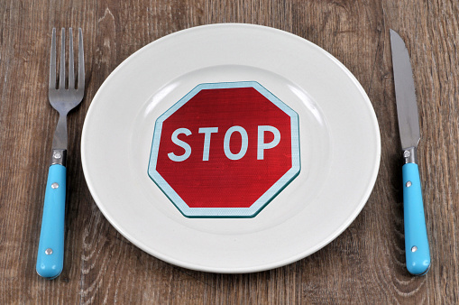 Diet concept with a stop sign on a plate