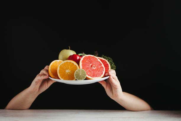 istock Hands holding plate with fresh healthy food 1301425032