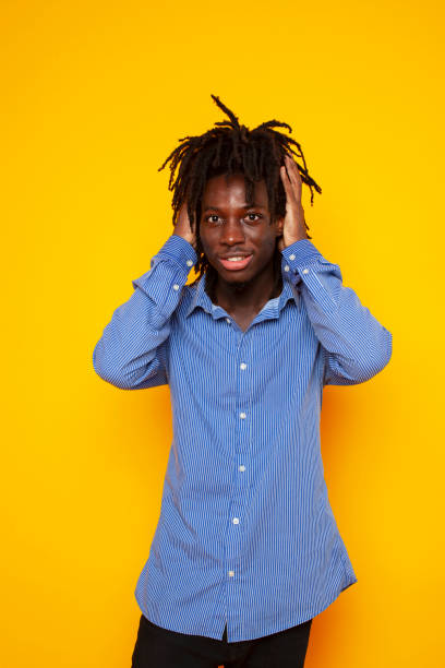 istock young handsome african american guy student posing cheerful and gesturing on yellow background, lifestyle people concept 1301426262