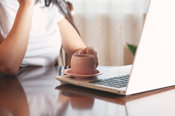 istock woman hand komputer  with coffee 1301427108