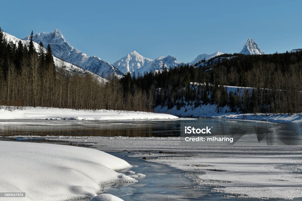 Flathead River and Glacier Park mountains Winter snow and Ice cover the middle-fork of the Flathead River and the northern Rockies' Montana - Western USA Stock Photo