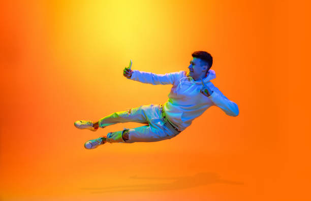 istock Caucasian beautiful man's portrait isolated on yellow studio background in multicolored neon light 1301428718